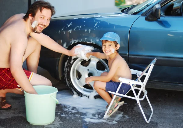 Child washing car and toy car with his father — Stock Photo, Image