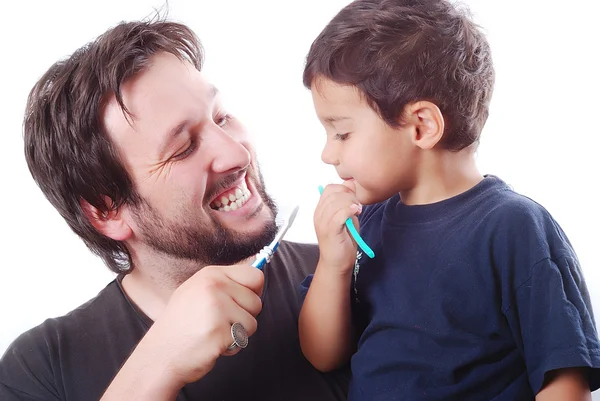 Otec učí svého syna, jak čistit zuby Stock Fotografie