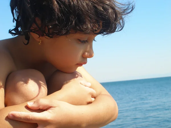 Little beautiful emotional girl sitting oh shore — Stock Photo, Image