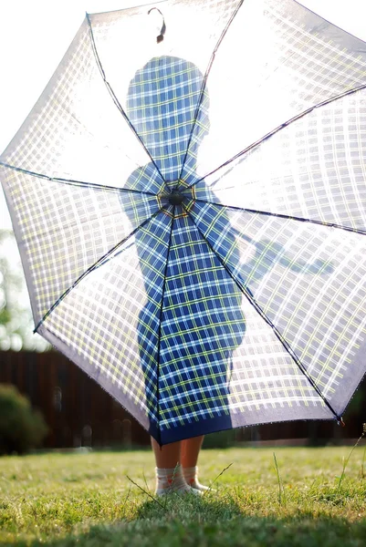 Kleiner Junge hält Regenschirm gegen die Sonne — Stockfoto