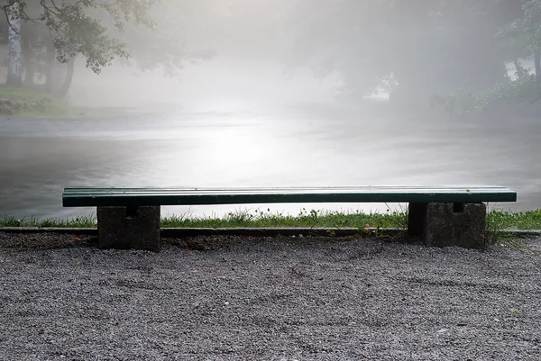 A bench aside the river — Stock Photo, Image