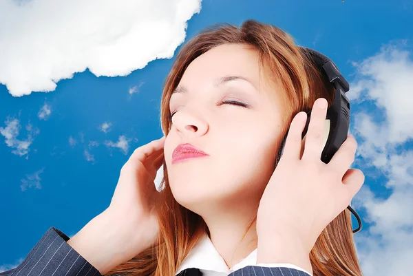 Sexy girl is listening to music in the sky — Stock Photo, Image