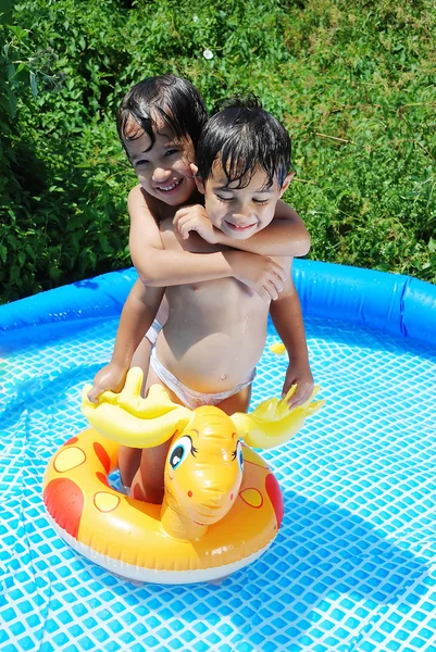 Children activities on swiming pool in summer — Stock Photo, Image