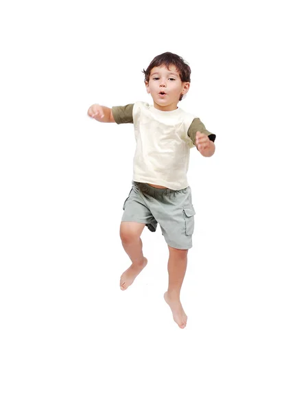 Happy little child in white clothes is jumping isolated — Stock Photo, Image