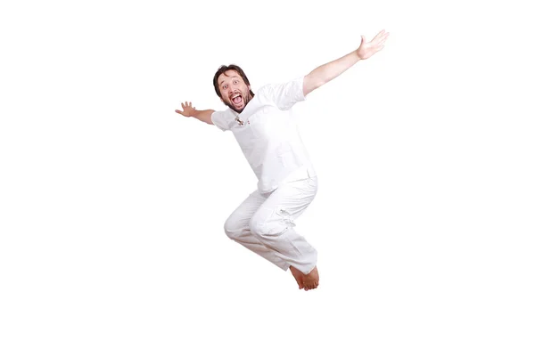 Happy young male in white clothes is jumping isolated — Stock Photo, Image