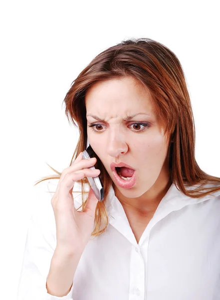Young brunette with angry expression on face speakin on cell phone Stock Photo