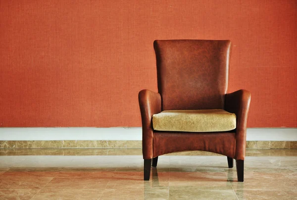 Vintage brown-gray chair standing beside the wall — Stock Photo, Image