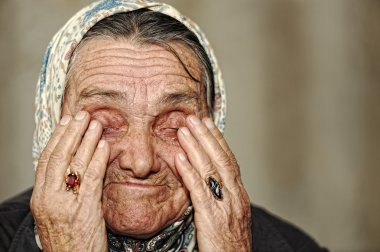 Olgun kadın eliyle yüzünde ağlıyor