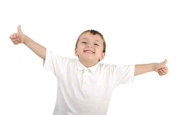 Sehr netter positiver lächelnder kleiner Junge, isoliert. Daumen hoch, glücklicher Sieger. — Stockfoto