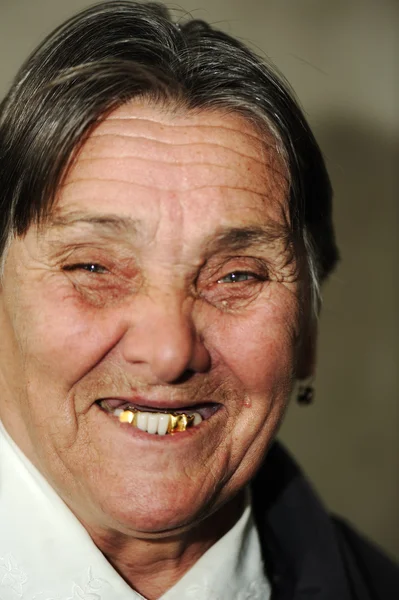 Portrait of laughing elderly woman with golden teeth — Stock Photo, Image