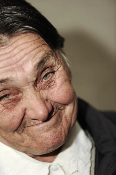 Portrait of laughing funny elderly woman with golden teeth making a grimace — Stock Photo, Image