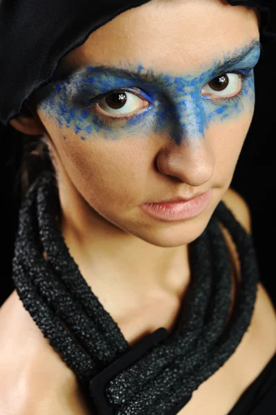 Very pretty woman with dark scarf and colorful mask eyes, fashion stylish model