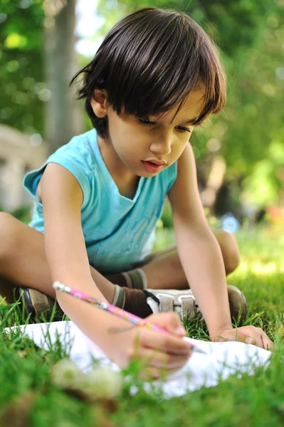 Writing kid boy , outdoor Royalty Free Stock Photos