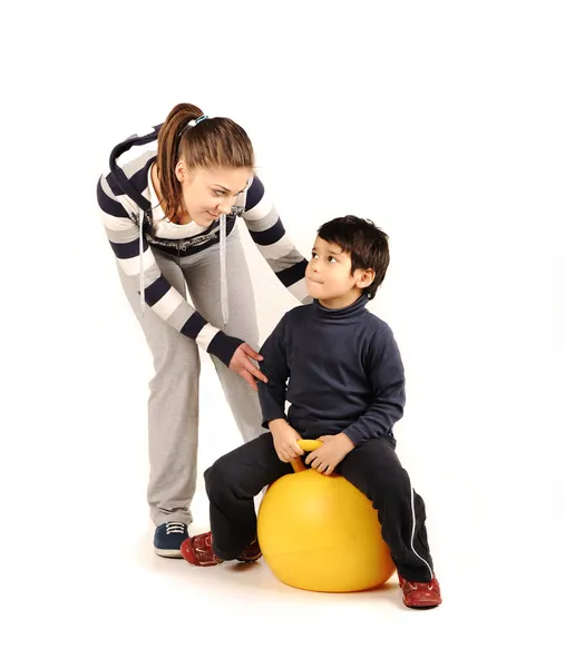 Family - young woman and kid - doing sport, fitness exercises — Stock Photo, Image