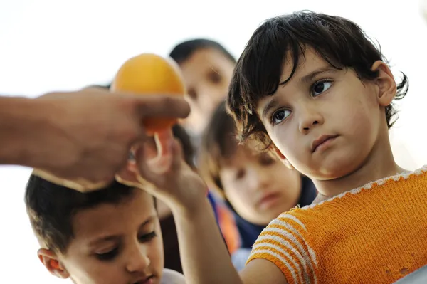 Hungry children in refugee camp, distribution of humanitarian food — Stock Photo, Image