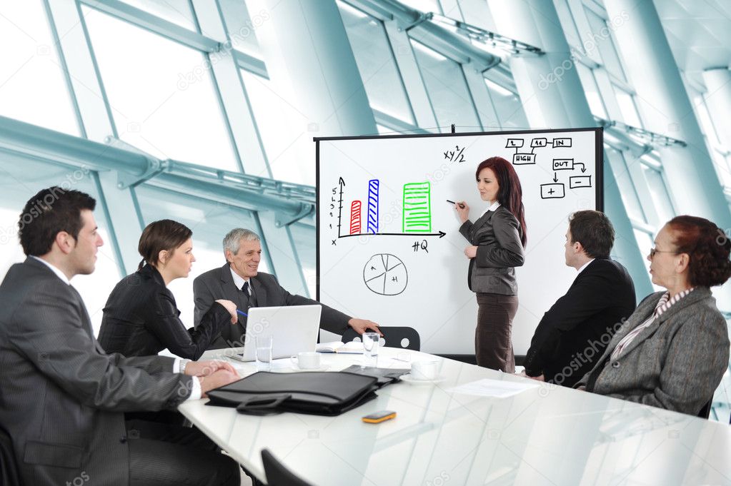 Businesswoman drawing a diagram during the presentation at offic