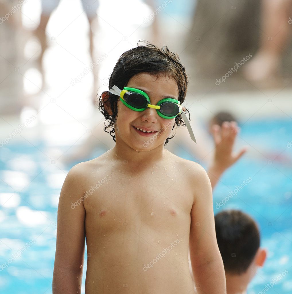 Little child on pool wearing goggles