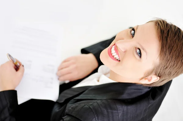 Young business woman at office signing a contract Royalty Free Stock Images