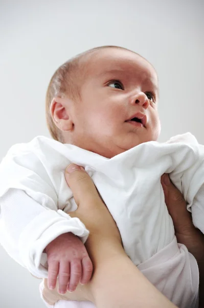 Newborn baby in mother's arms Stock Photo