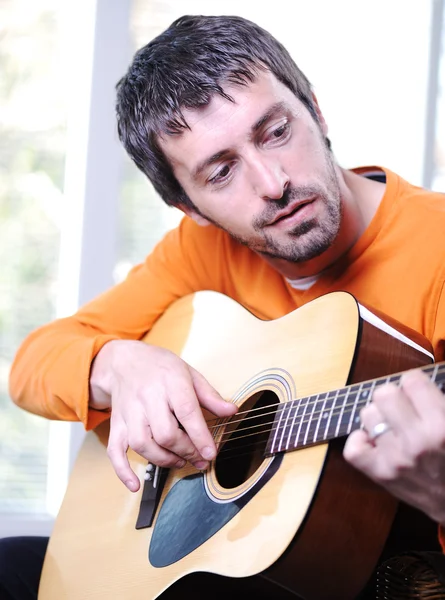 Male adult playing guitar — Stock Photo, Image