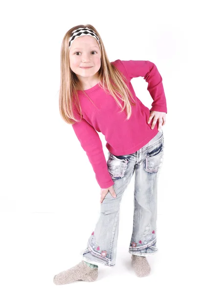 Cute little girl standing in studio — Stock Photo, Image