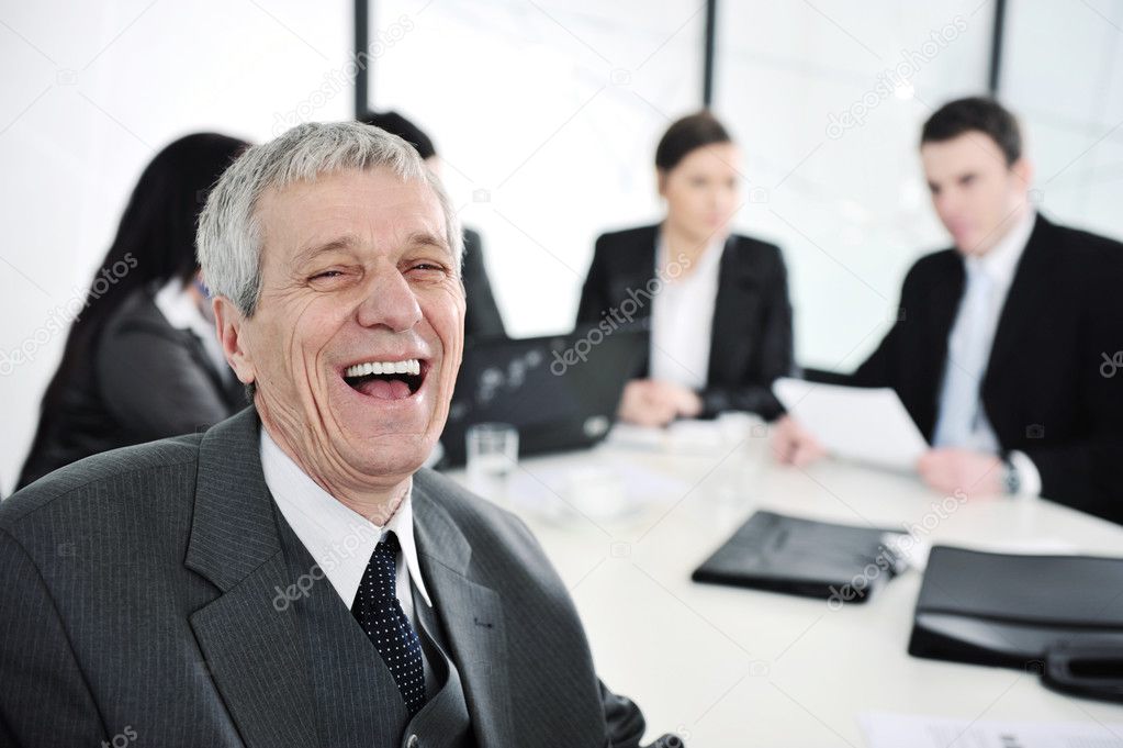 Senior businessman laughing at office meeting