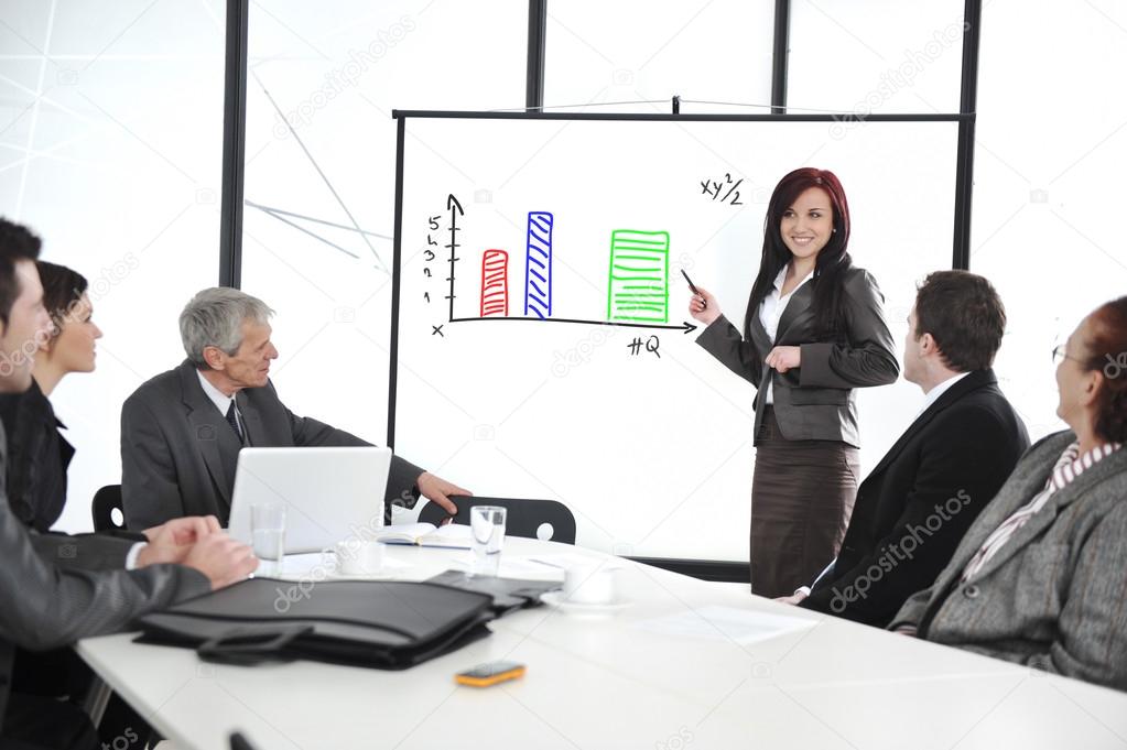 Business meeting - group of in office at presentation with flipchart