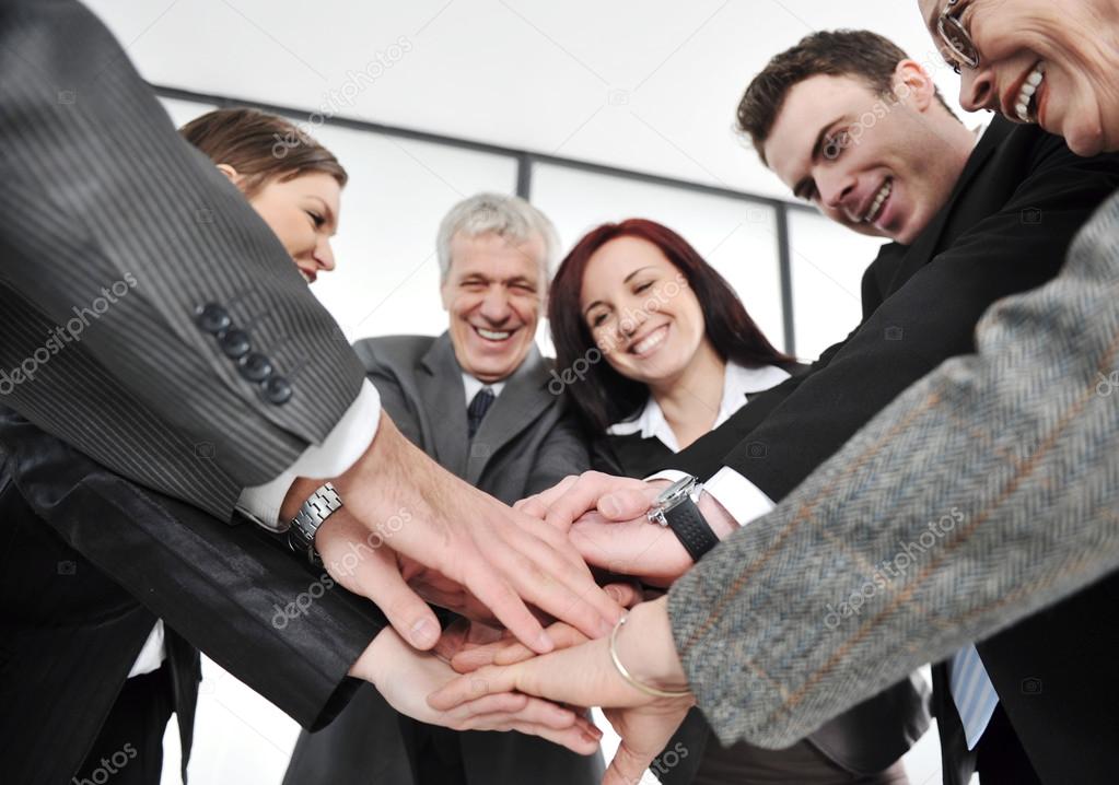 Group of executives placing their hands together