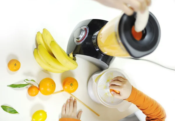 Blender making fruit juice in kitchen — Stock Photo, Image