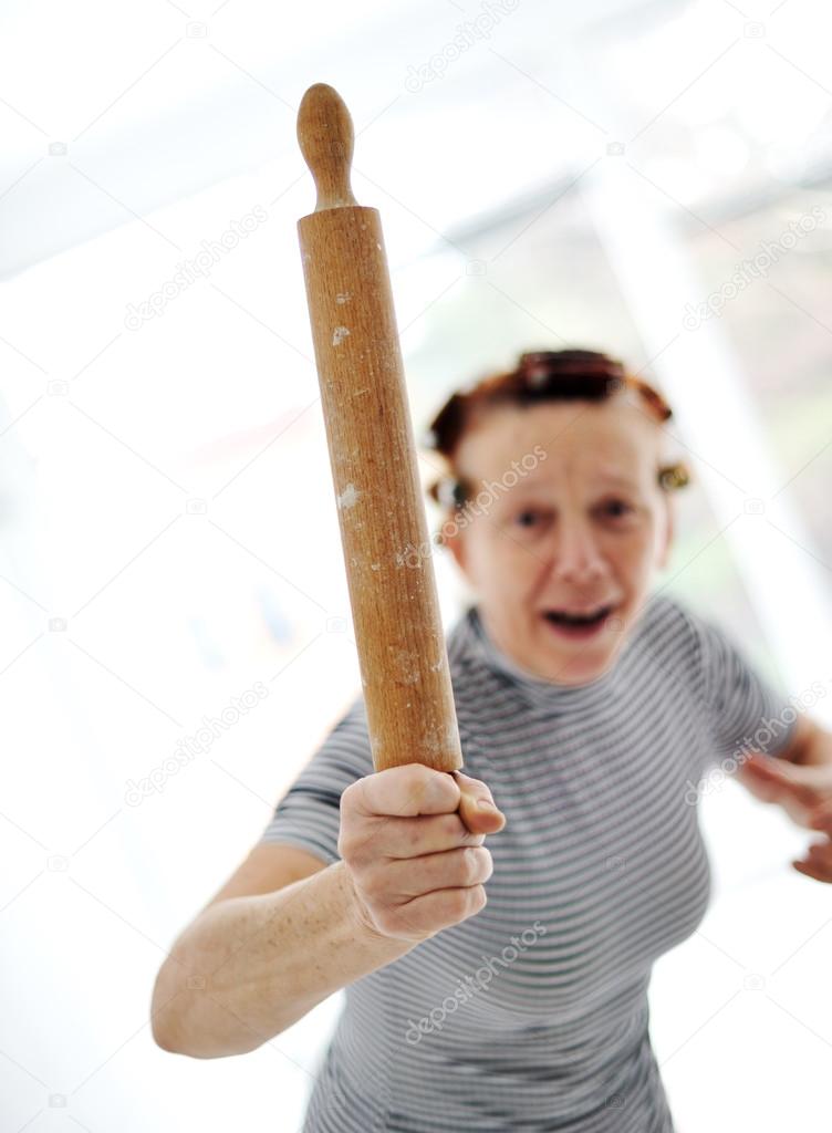 Angry older woman with rolling pin