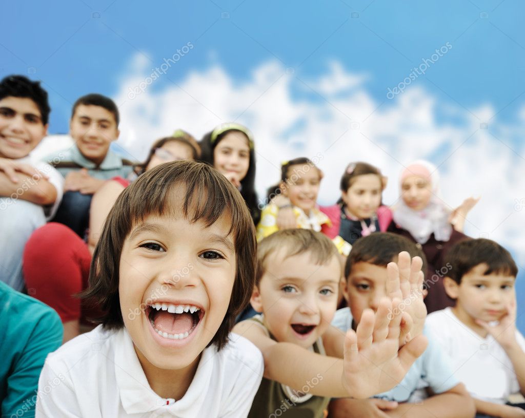 Crowd of children, different ages and races in front of the scho