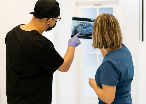 Two doctors checking x-ray image in hospital, high quality photo — Stock Photo, Image