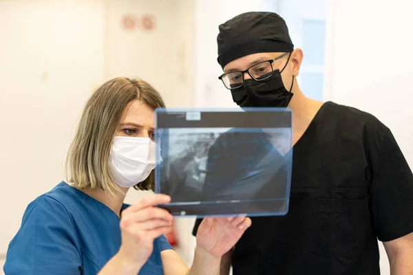 Two doctors checking x-ray image in hospital, high quality photo — Stock Photo, Image