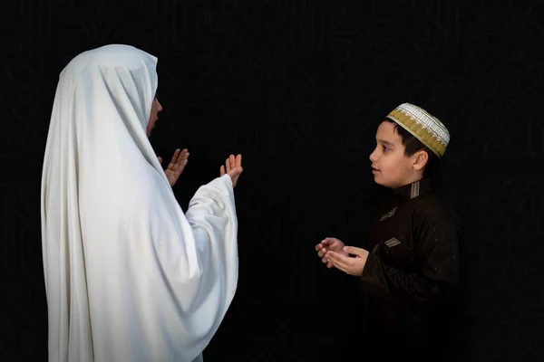 Muslim woman and son pilgrims in white traditional clothes, praying at Kaaba in Makkah — Stock Photo, Image