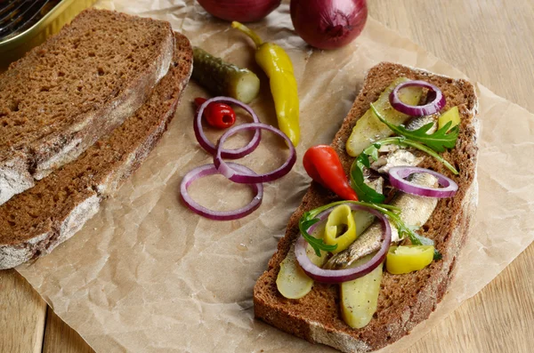 Sprat sandwich with pickled vegetables — Stock Image Sprat sandwich with pickled vegetables Stock Image