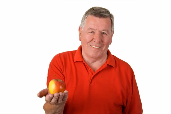 Alter Mann mit einem Apfel in der Hand — Stockfoto