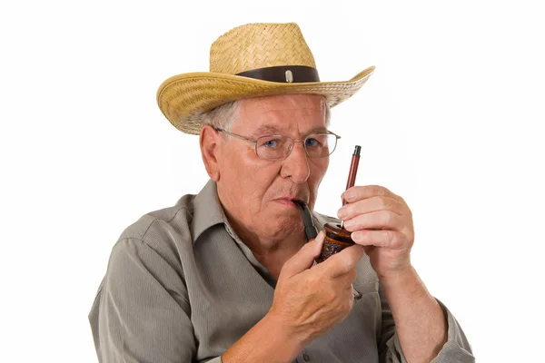 Old man lighting up a pipe — Stock Photo, Image