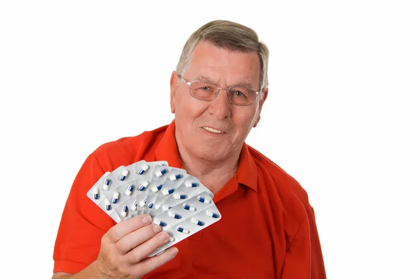 Homem idoso segurando medicamentos — Fotografia de Stock