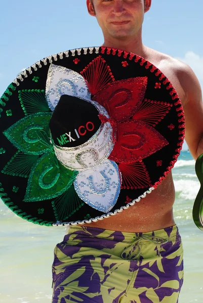 Man on the exotic beach with sombrero — Stock Photo, Image