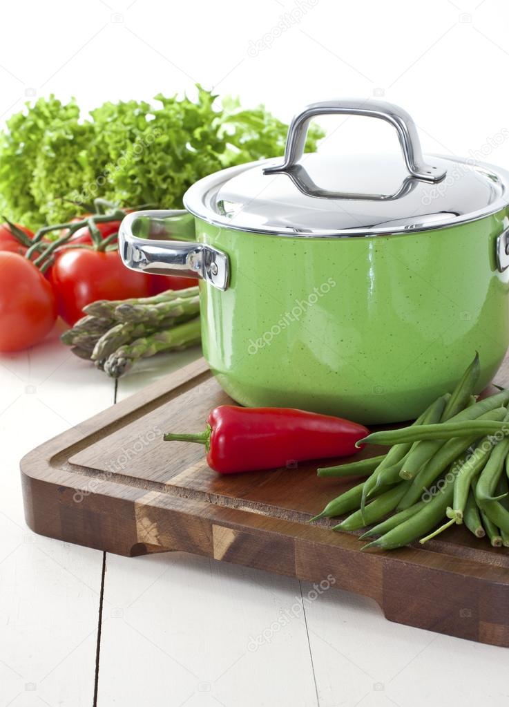 Green cooking pot and vegetables