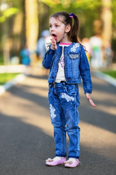 Pretty little girl licking her own fingers — Stock Photo, Image