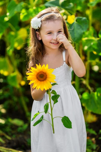 Young smiling girl with sunflower — Stock Fotó