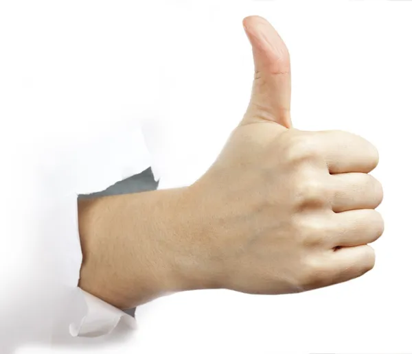 Hand with thumb up through a hole in paper — Stock Photo, Image