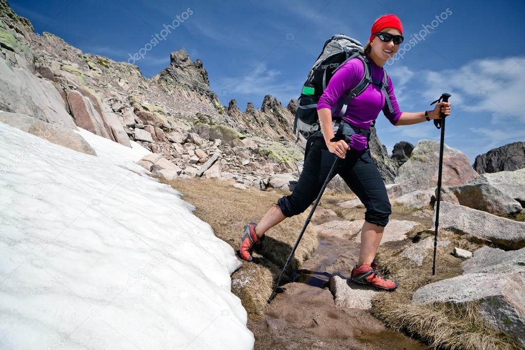 Hiking woman in mountains with snow