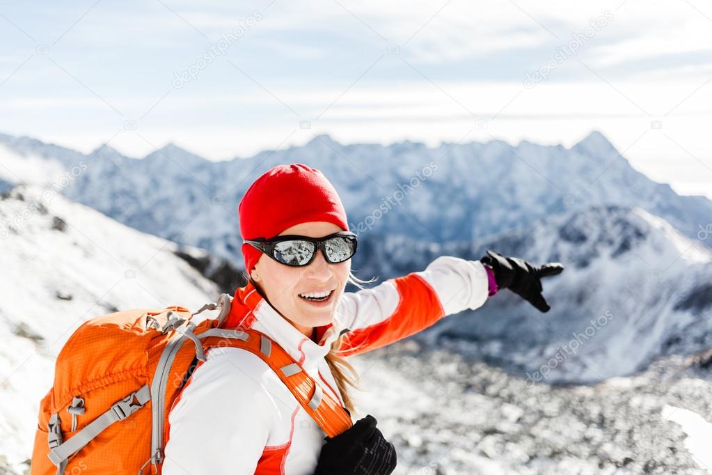 Hiking success, happy woman in winter mountains