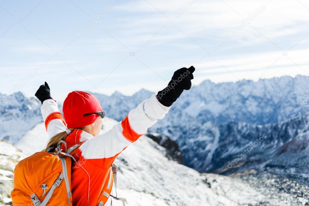 Hiking success, woman in winter mountains