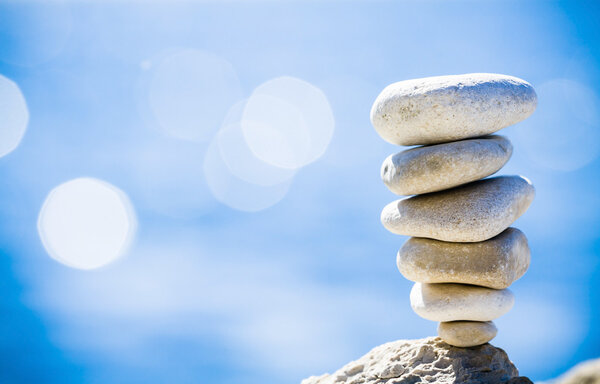 Stones balance, pebbles stack over blue sea in Croatia. Stock Image