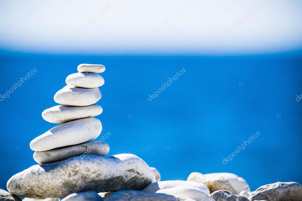 Stones balance, pebbles stack over blue sea in Croatia.