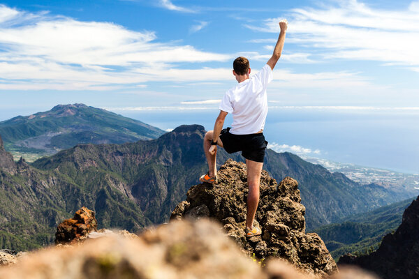 Trail runner success, man running in mountains