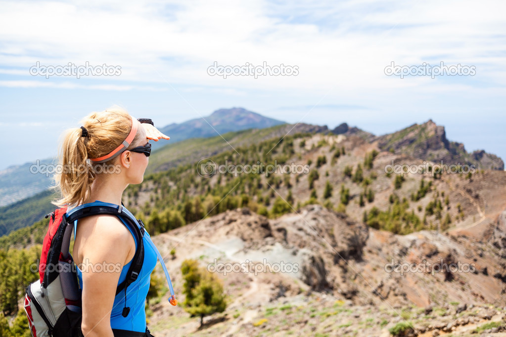 Hiking woman, runner in summer mountains